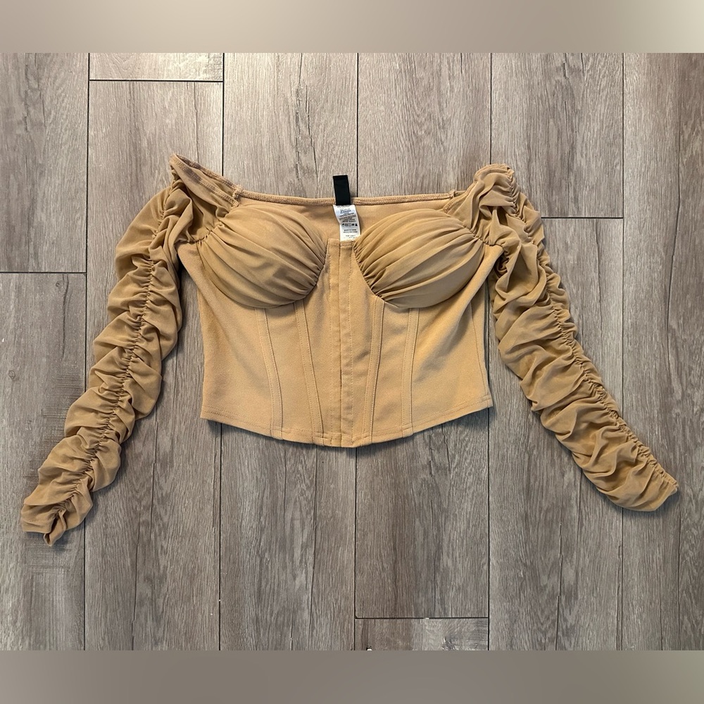 Cropped corset top with mesh sleeves.